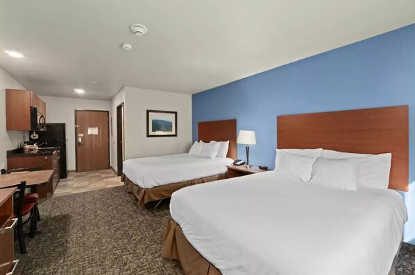 A hotel room with two beds, a desk, a chair, a lamp, and a picture on the wall. - Mainstay Suites Spokane Valley, WA (Spokane Valley)
