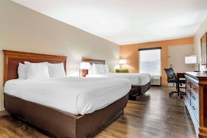A hotel room with two beds, a desk, a chair, and a large window. - Econo Lodge Moss Point - Pascagoula (Moss Point)