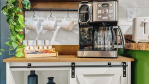 A kitchenette with a coffee maker, mugs, and storage containers. - 1 mile Pkwy~Single level ~ Sauna, Outdoor Movies (Pigeon Forge)