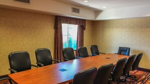 A conference room with a long wooden table and eight black chairs. - Best Western Lubbock West Inn and Suites (Lubbock)