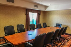 A conference room with a long wooden table and eight black chairs. - Best Western Lubbock West Inn and Suites (Lubbock)