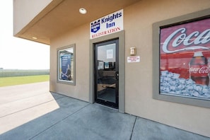 A Knights Inn registration sign, an emergency pump switch off sign, and a Coca-Cola poster. - King City Motel by OYO Pasco (Pasco)