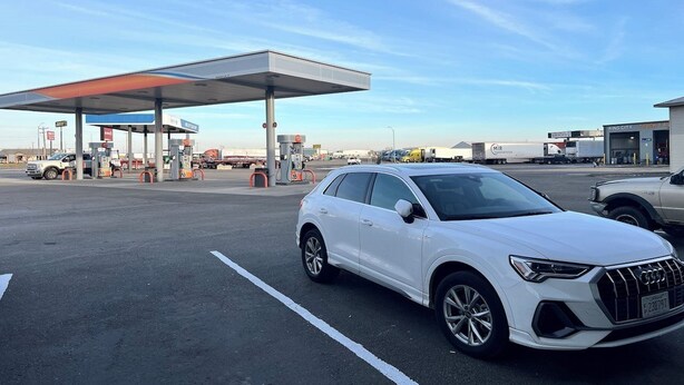 A white SUV parked at a gas station with a clear sky. - King City Motel by OYO Pasco (Pasco)