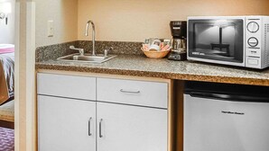 A kitchenette with a sink, a microwave, a coffee maker, and a dishwasher. - Quality Inn & Suites Roswell (Roswell)