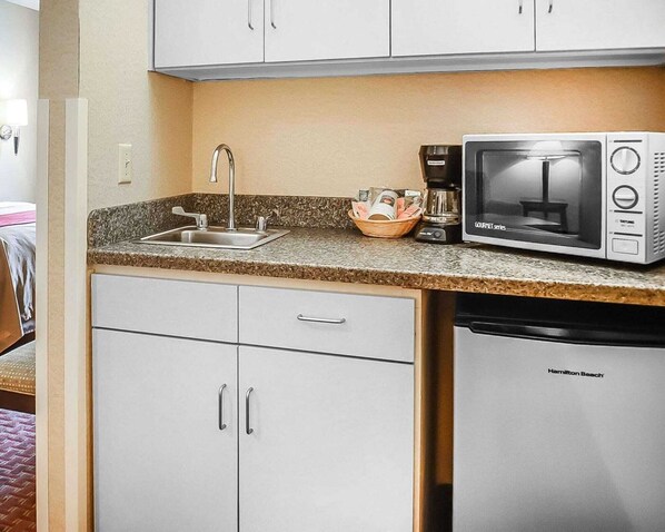 A kitchenette with a sink, a microwave, a coffee maker, and a dishwasher. - Quality Inn & Suites Roswell (Roswell)