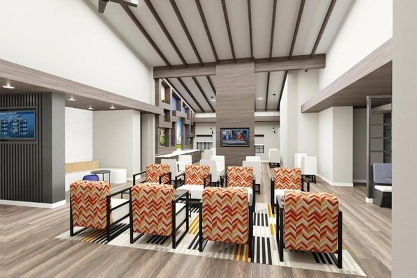 A modern hotel lobby with a central seating area, a reception desk, and a digital display. - Clarion Pointe Rhinelander Downtown (Rhinelander)