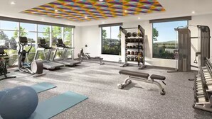 A modern gym with various exercise equipment, large windows, and a geometric ceiling design. - Home2 Suites by Hilton Somerset (Somerset)