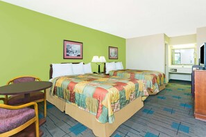 A hotel room with two beds, a desk, a chair, and a bathroom visible through an open door. - Days Inn by Wyndham Clemson (Clemson)