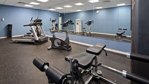 A gym with various exercise equipment, including treadmills, stationary bikes, and weight machines. - Ramada by Wyndham Cocoa (Cocoa)