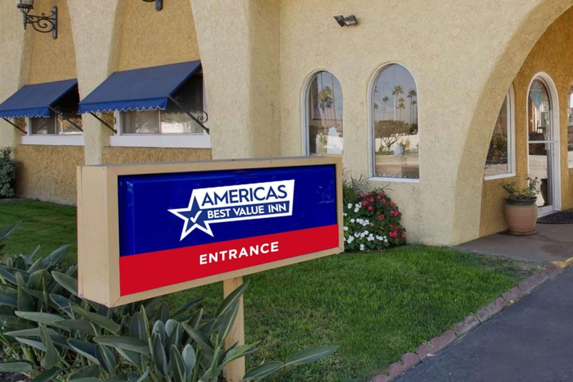An entrance sign for Americas Best Value Inn with a star logo and the words 'AMERICAS BEST VALUE INN' and 'ENTRANCE' on a blue and red background.