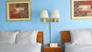 A hotel room with two beds, a nightstand with a lamp, and two framed artworks on the wall. - Surestay by Best Western Glendive Yellowstone River (Glendive)