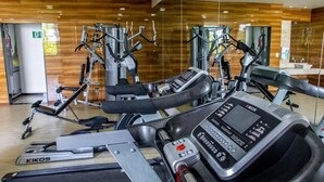 Un gimnasio con diversas máquinas de cardio, incluyendo cintas de correr y elípticas.