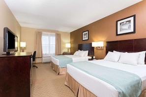 A hotel room with two beds, a desk with a TV, a chair, and a window with curtains. - Holiday Inn Express & Suites Palm Coast - I-95 (Palm Coast)