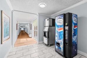 A hallway with a refrigerator and a vending machine. - Econo Lodge Montgomery South I-65 (Montgomery)