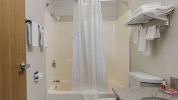 A bathroom with a shower, toilet, and sink.