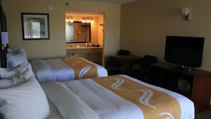 A hotel room with two beds, a television, a desk, and a bathroom visible through an open door. - Motel6 Willcox, AZ (Willcox)