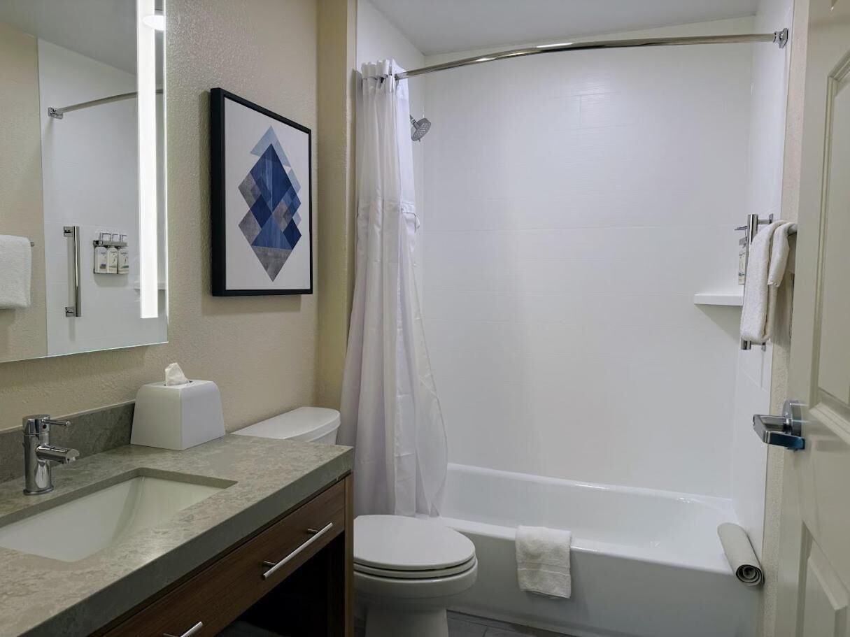 A bathroom with a sink, toilet, and bathtub.