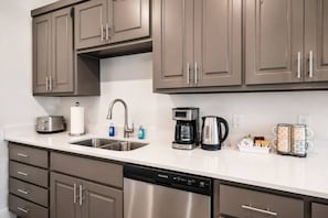 A modern kitchen with stainless steel appliances, a dishwasher, and a coffee maker. - New Modern Stay Near Hot Springs National Park (Hot Springs)