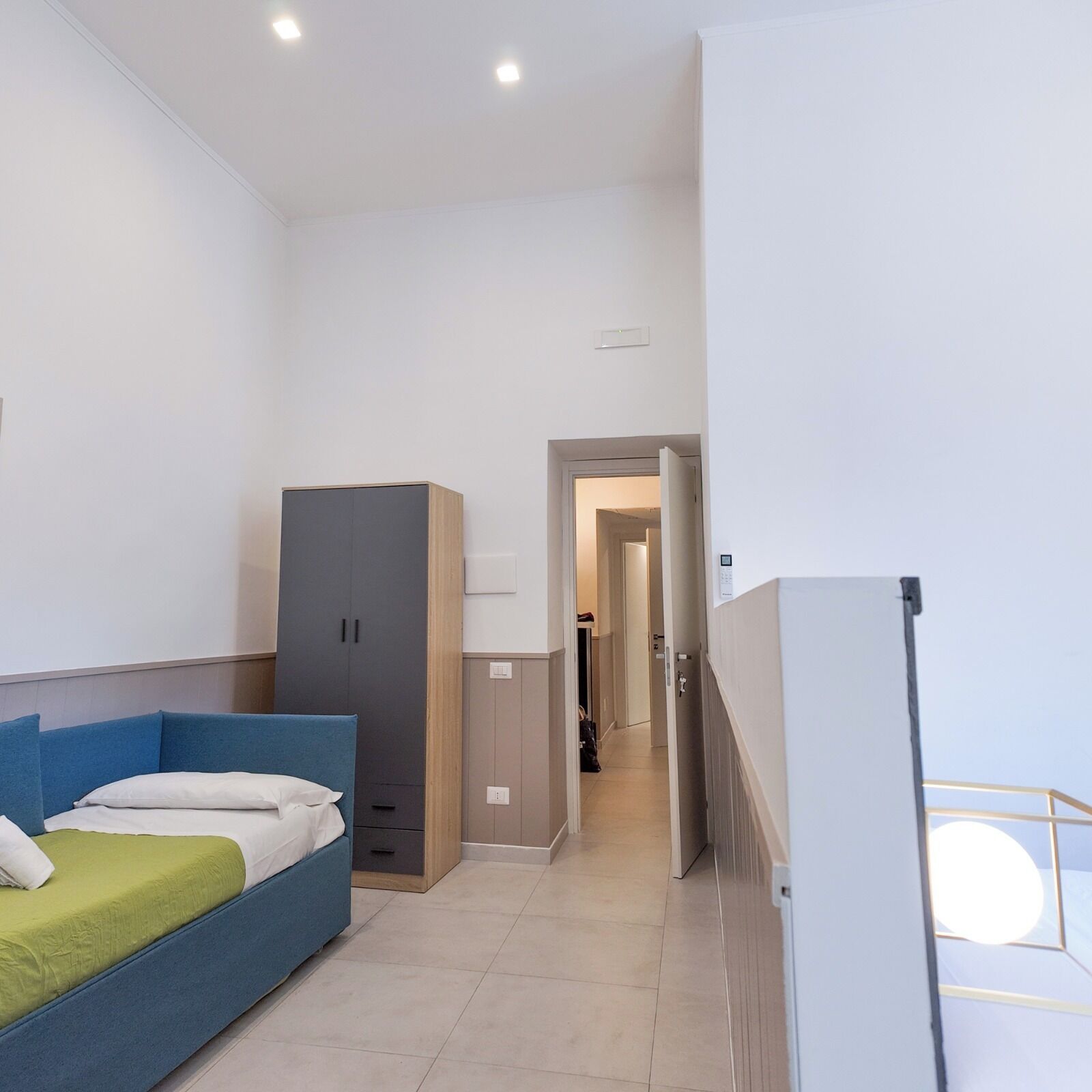 A modern bedroom with a bed, wardrobe, and a walk-in closet.