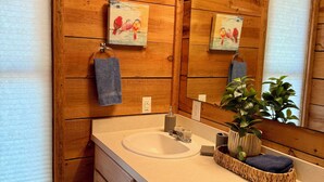 A wooden bathroom with a sink, mirror, and two towels. - Blue Spirit · Private Studio Cabin in the Trees (Caddo Gap)