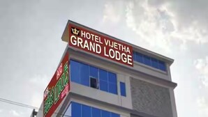 A multi-story building with a prominent sign for Hotel Vijetha Grand Lodge. - VIJETHA GRAND LODGE  (Mangalagiri)