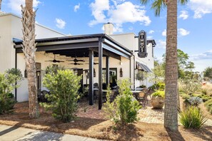 A restaurant with outdoor seating, palm trees, and a clear blue sky. - Private Pool, LSV/Golf Cart, Bikes, & Pet Friendly! 1/2 MILE TO BLUE MOUNTAIN BEACH! (Santa Rosa Beach)