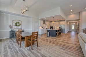 A spacious kitchen with a dining area, wooden flooring, and pendant lighting. - Lakefront Lake Anna, Dock, Deck, Views, Games (Mineral)
