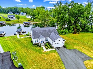 A residential property with a large house, a dock, and a pond. - Lakefront Lake Anna, Dock, Deck, Views, Games (Mineral)