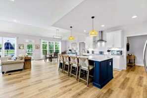 A modern kitchen with a central island, pendant lighting, and a view of the outdoors. - Lakefront Lake Anna, Dock, Deck, Views, Games (Mineral)