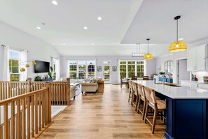 A spacious kitchen with a central island, wooden flooring, and large windows. - Lakefront Lake Anna, Dock, Deck, Views, Games (Mineral)