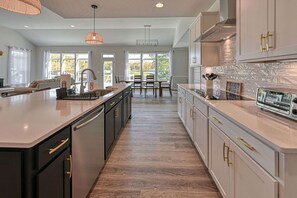 A modern kitchen with a central island, stainless steel appliances, and a view to the outdoors. - Lakefront Lake Anna, Dock, Deck, Views, Games (Mineral)