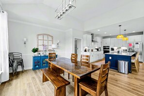 A modern kitchen with white cabinets, stainless steel appliances, and a blue island. - Lakefront Lake Anna, Dock, Deck, Views, Games (Mineral)
