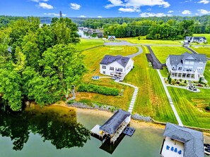 A residential area with a large house, a dock, and a lake. - Lakefront Lake Anna, Dock, Deck, Views, Games (Mineral)