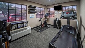 A gym with a treadmill, stationary bike, and a water cooler. - La Quinta Inn & Suites Tempe University / Phoenix (Tempe)