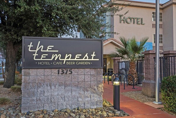 A sign for 'The Tempest Hotel & Cafe Beer Garden' with a stone base and the number 1375. - La Quinta Inn & Suites Tempe University / Phoenix (Tempe)