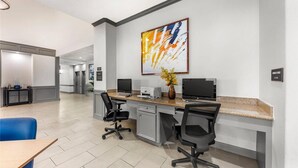 A modern office space with two desks, chairs, and a large abstract painting on the wall. - Comfort Inn & Suites Schulenburg TX (Schulenburg)