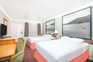 A hotel room with two beds, a desk, a television, and a large window with a lake view. - Upper Lake Inn & Suites (Upper Lake)