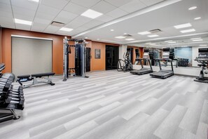 A gym with treadmills, weight machines, and a bench. - Candlewood Suites Cincinnati Northeast - Mason (Mason)