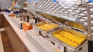 A buffet with various food items, including omelets and cheese. - Holiday Inn Express Kitty Hawk Outer Banks (Kitty Hawk)