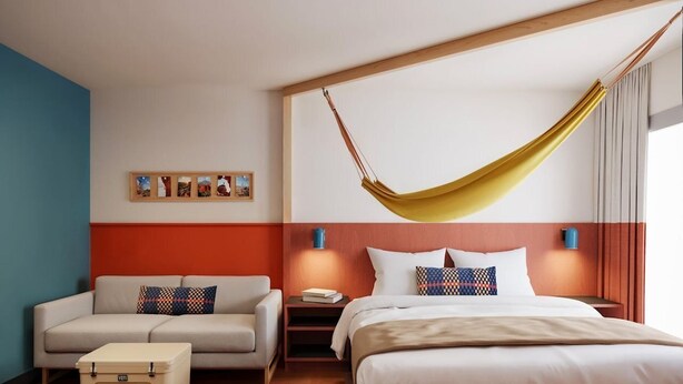 A hotel room with a bed, a sofa, a nightstand, a suitcase, and a hammock. - Loge St. George (St. George)