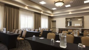 A conference room with tables, chairs, and a large mirror on the wall. - Toms River (Toms River)