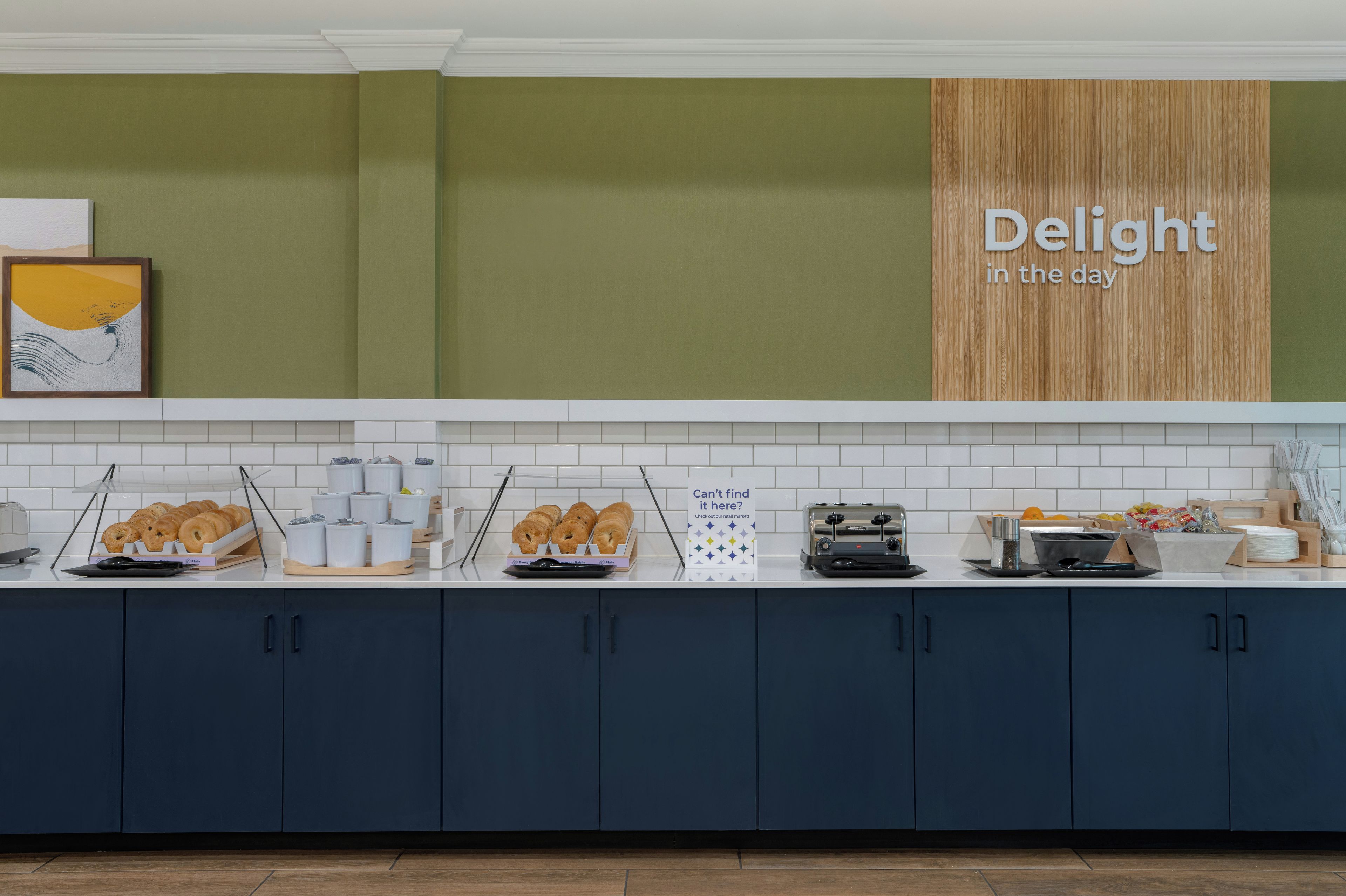 A breakfast buffet with various food items and a sign that reads 'Delight in the day'.
