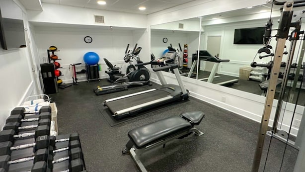 A gym with treadmills, stationary bikes, free weights, and exercise balls. - Sonesta Essential Hotels Overland Park (Overland Park)