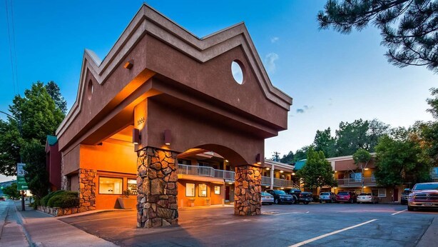 A hotel with a unique architectural design featuring a prominent overhang and stone pillars. - Baymont by Wyndham Durango (Durango)