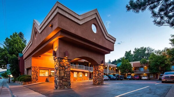 A hotel with a unique architectural design featuring a prominent overhang and stone pillars. - Baymont by Wyndham Durango (Durango)