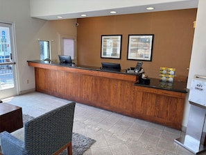 A reception desk with a computer, a key drop box, and framed pictures on the wall. - Best Western San Diego Pacific Beach/mission Bay (San Diego)
