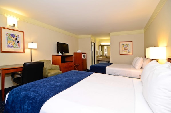 A hotel room with two beds, a desk with a chair, a television, and framed artwork on the walls. - Best Western San Diego Pacific Beach/mission Bay (San Diego)