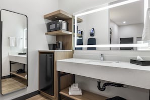A modern bathroom with a large mirror, a sink, a microwave, and a coffee maker. - Best Western San Diego Pacific Beach/mission Bay (San Diego)