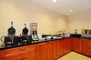 A kitchen with waffle makers, a coffee machine, and a bread display. - Best Western San Diego Pacific Beach/mission Bay (San Diego)