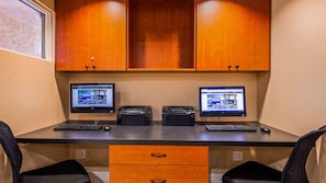 A desk with two monitors, two keyboards, and two mice. There are wooden cabinets above the desk and a drawer below it. - Best Western San Diego Pacific Beach/mission Bay (San Diego)